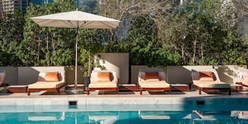 a pool with chairs and umbrella
