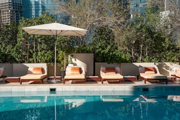 a pool with chairs and umbrella