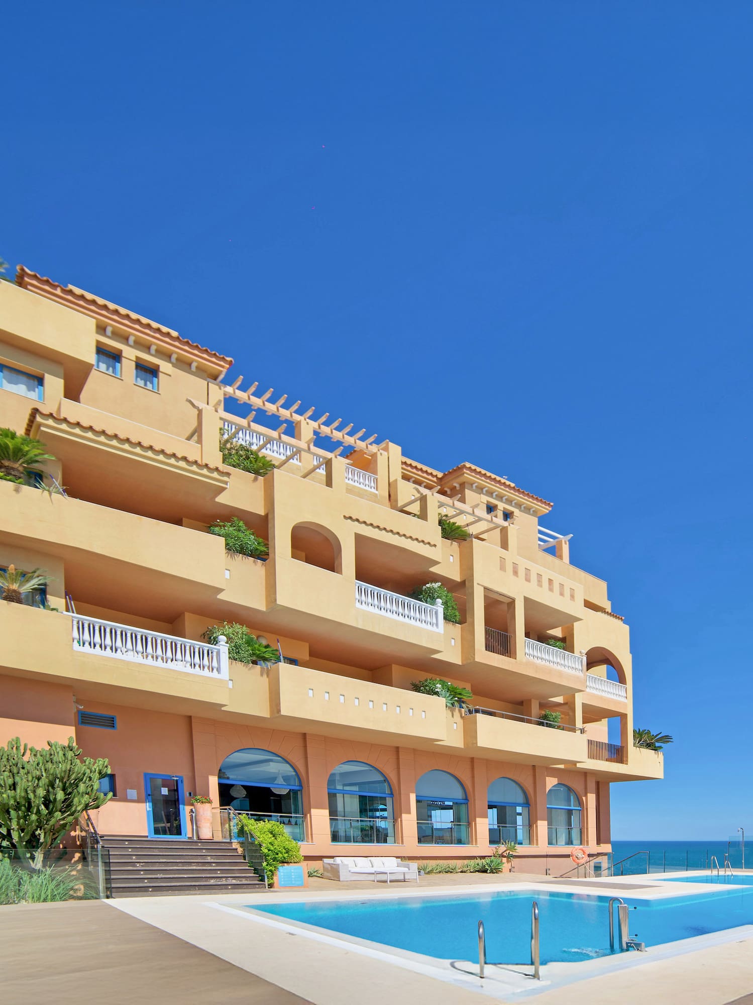 a building with a pool in front of it