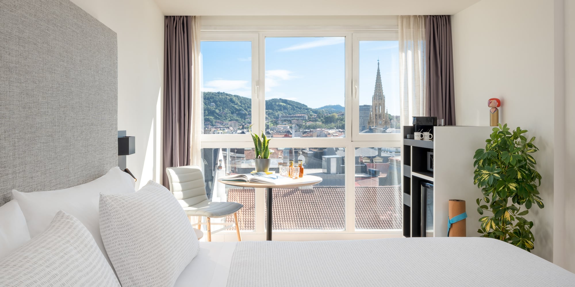 a bedroom with a table and chairs and a table with a window