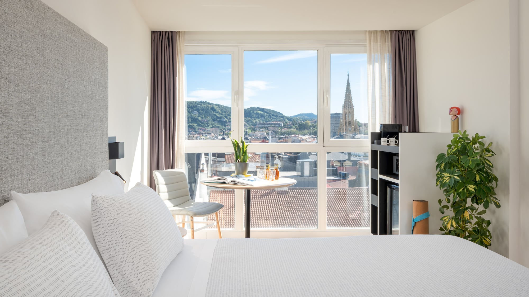 a bedroom with a table and chairs and a table with a window