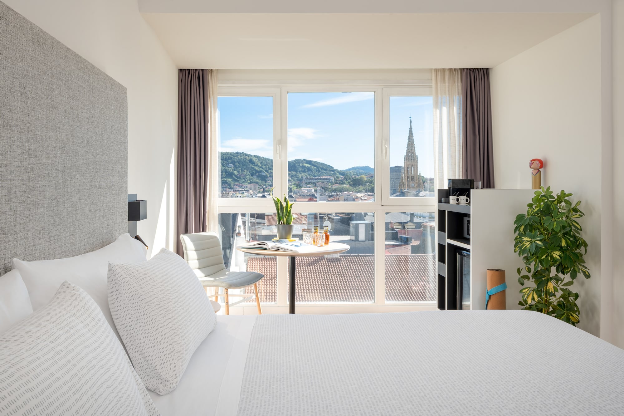 a bedroom with a table and chairs and a table with a window