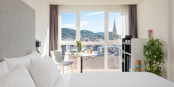 a bedroom with a table and chairs and a table with a window