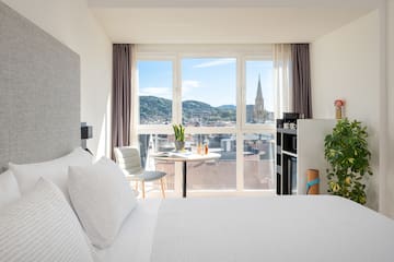 a bedroom with a table and chairs and a table with a window