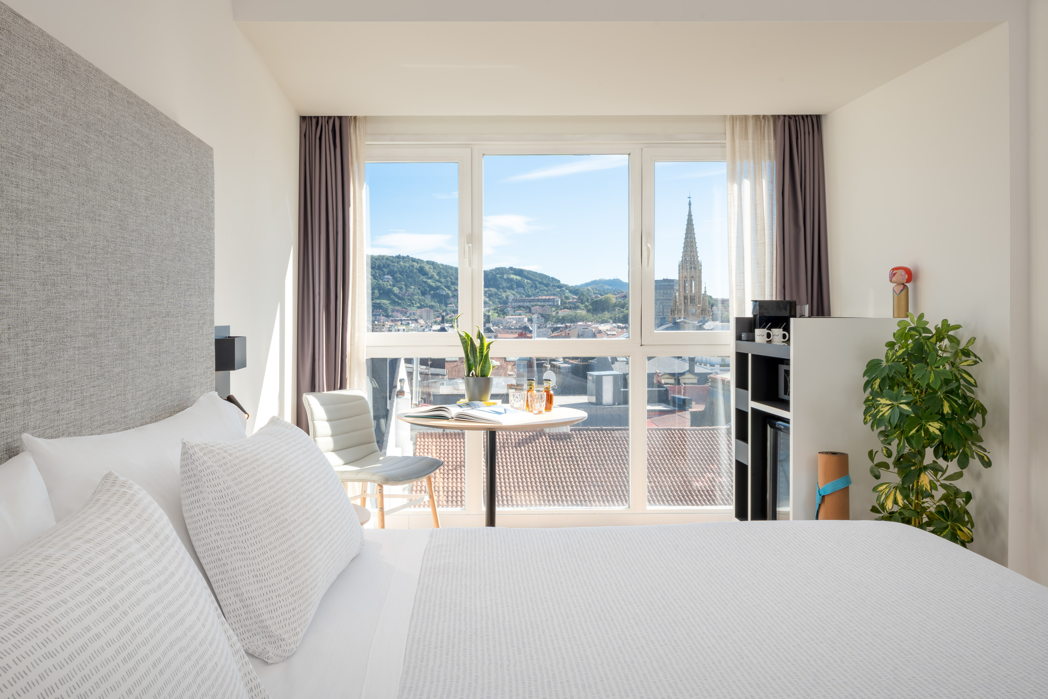 a bedroom with a table and chairs and a table with a window