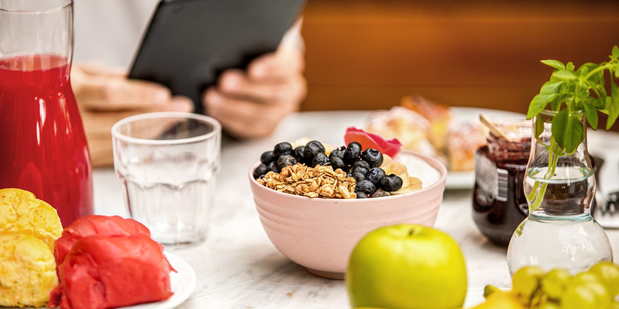 a bowl of cereal and fruits on a table