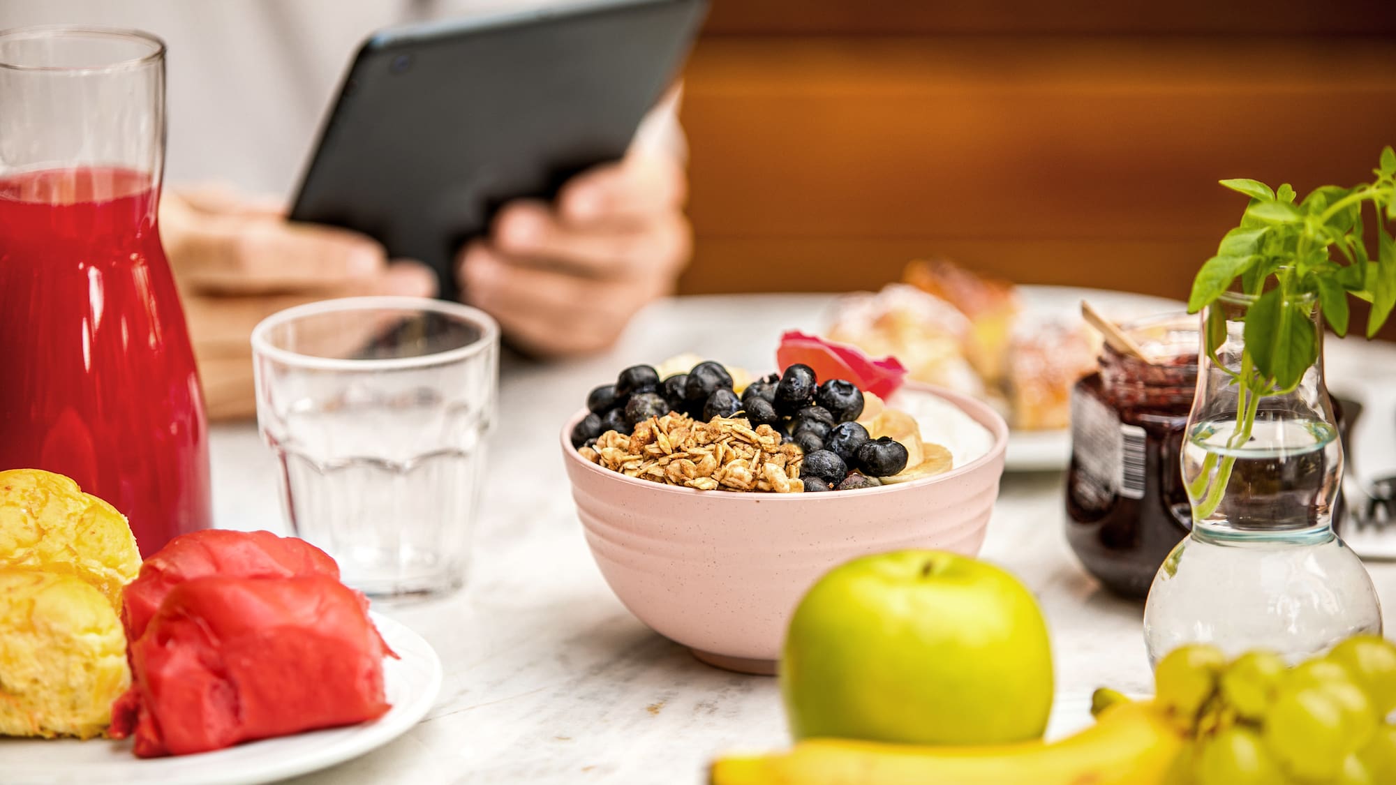 a bowl of cereal and fruits on a table