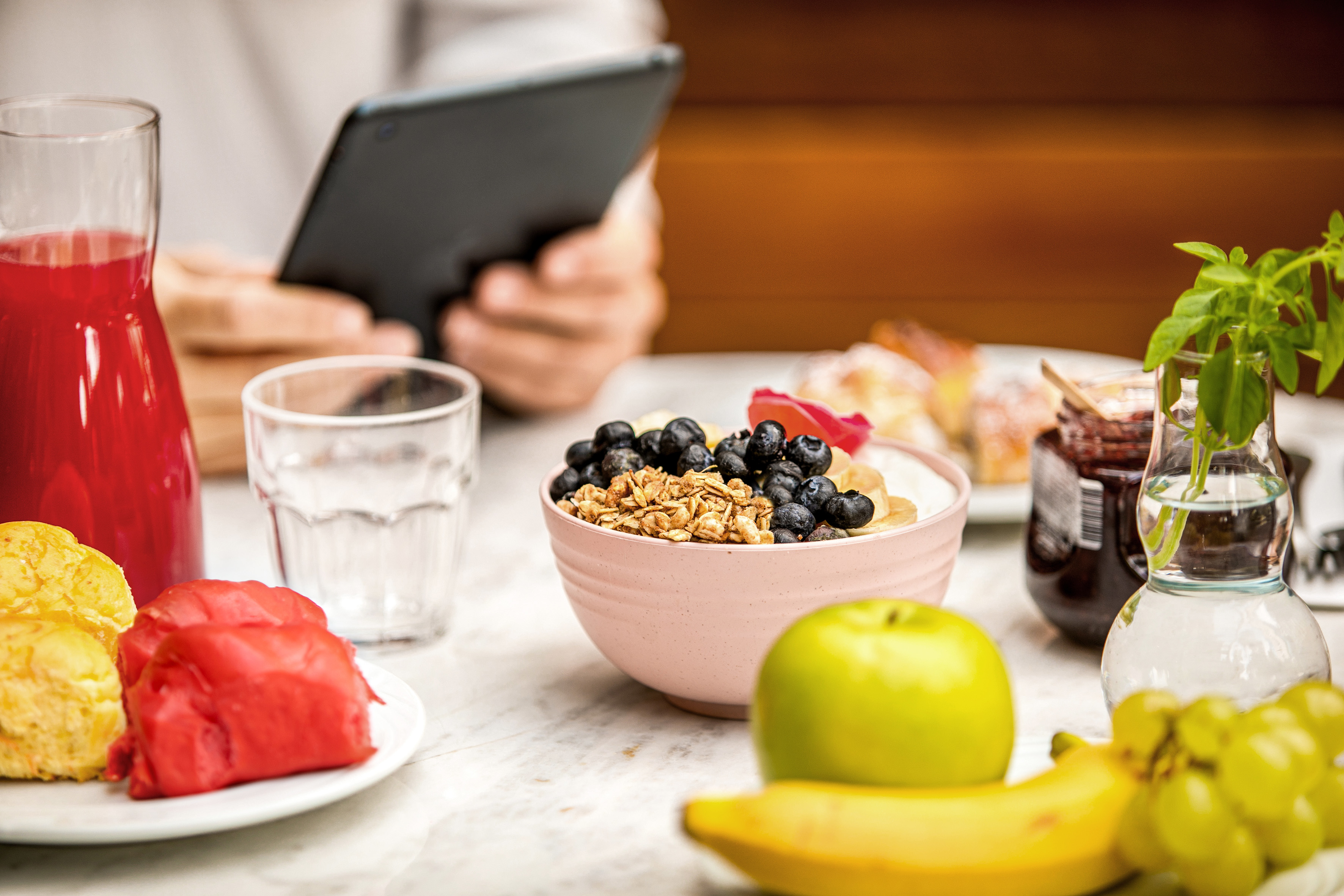 a bowl of cereal and fruits on a table