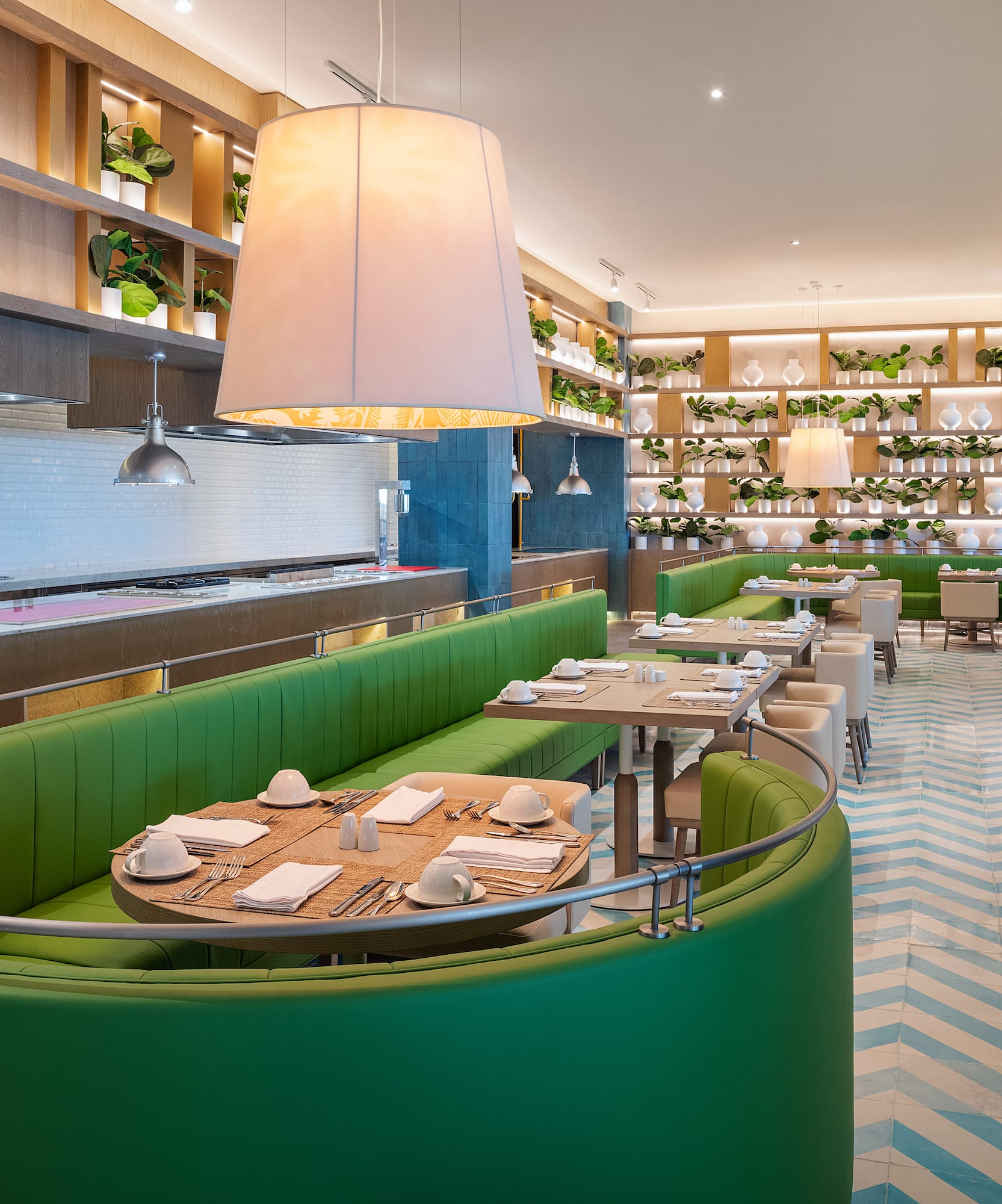 a restaurant with green booth seating and white and blue walls