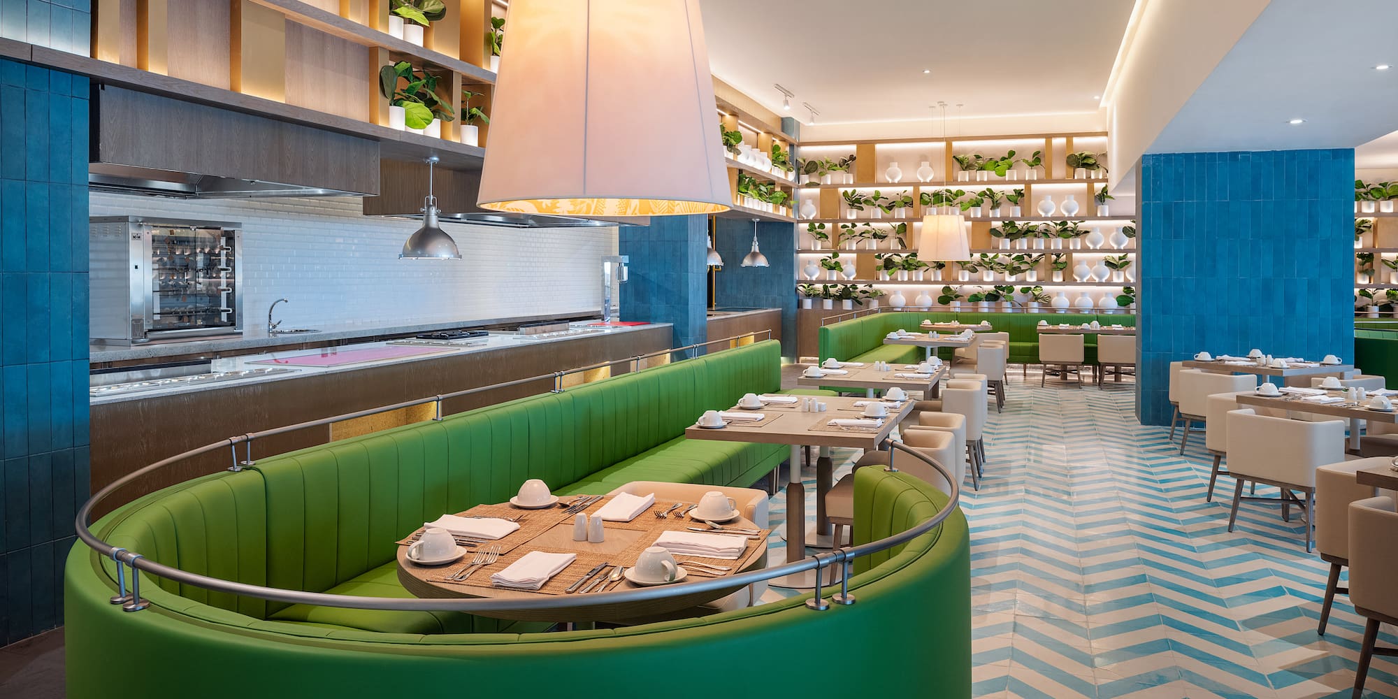 a restaurant with green booth seating and white and blue walls