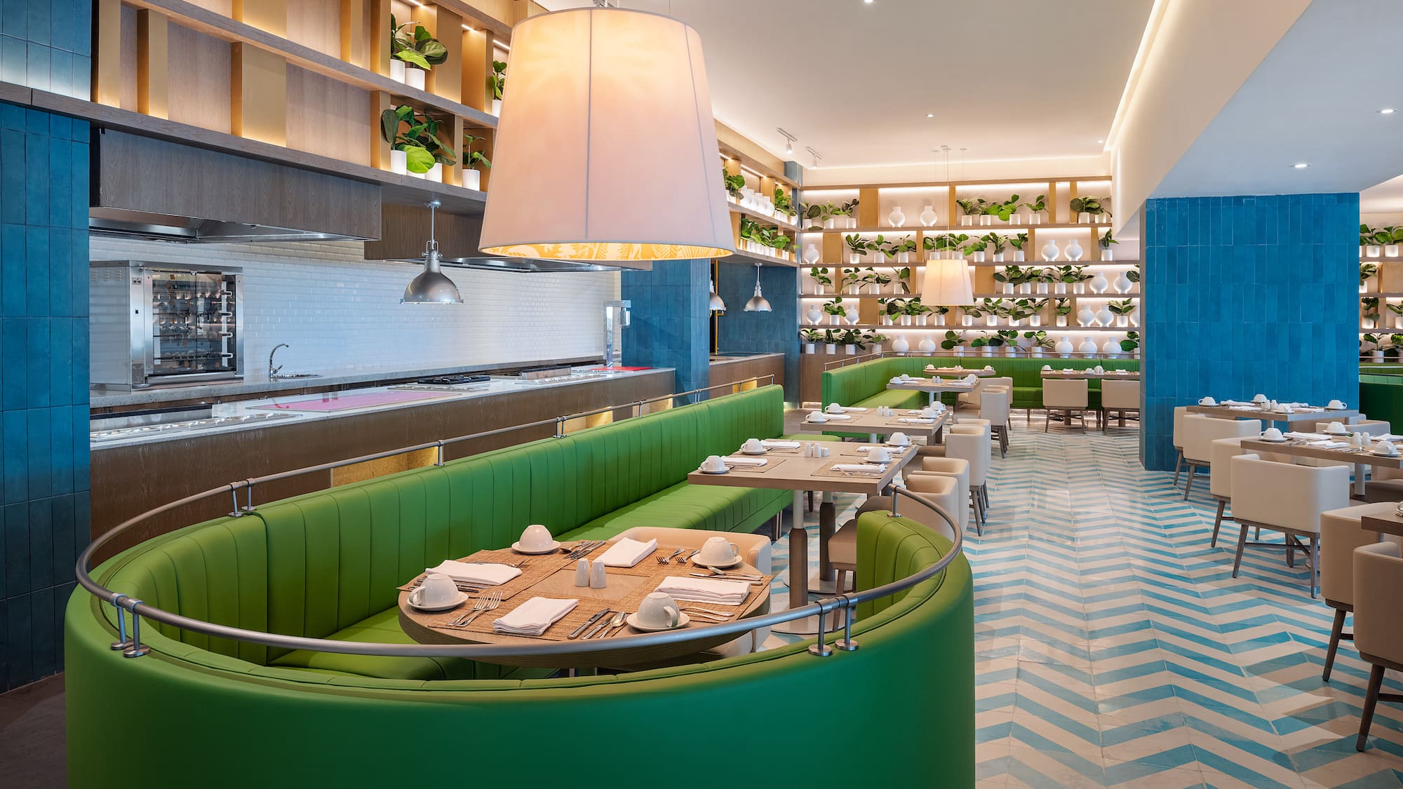 a restaurant with green booth seating and white and blue walls