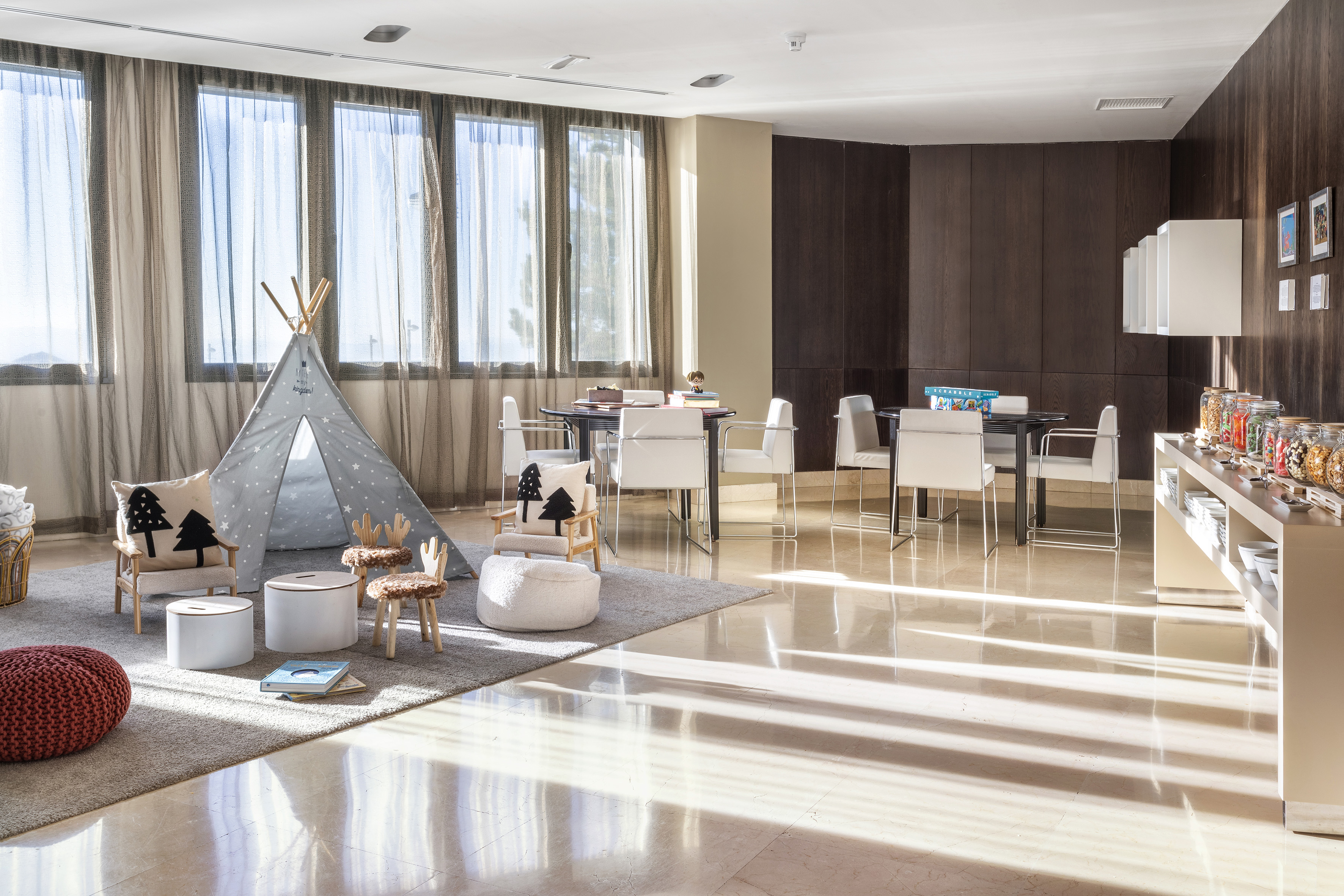 a room with a tent and chairs