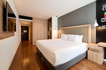 a room with a bed and a wood floor