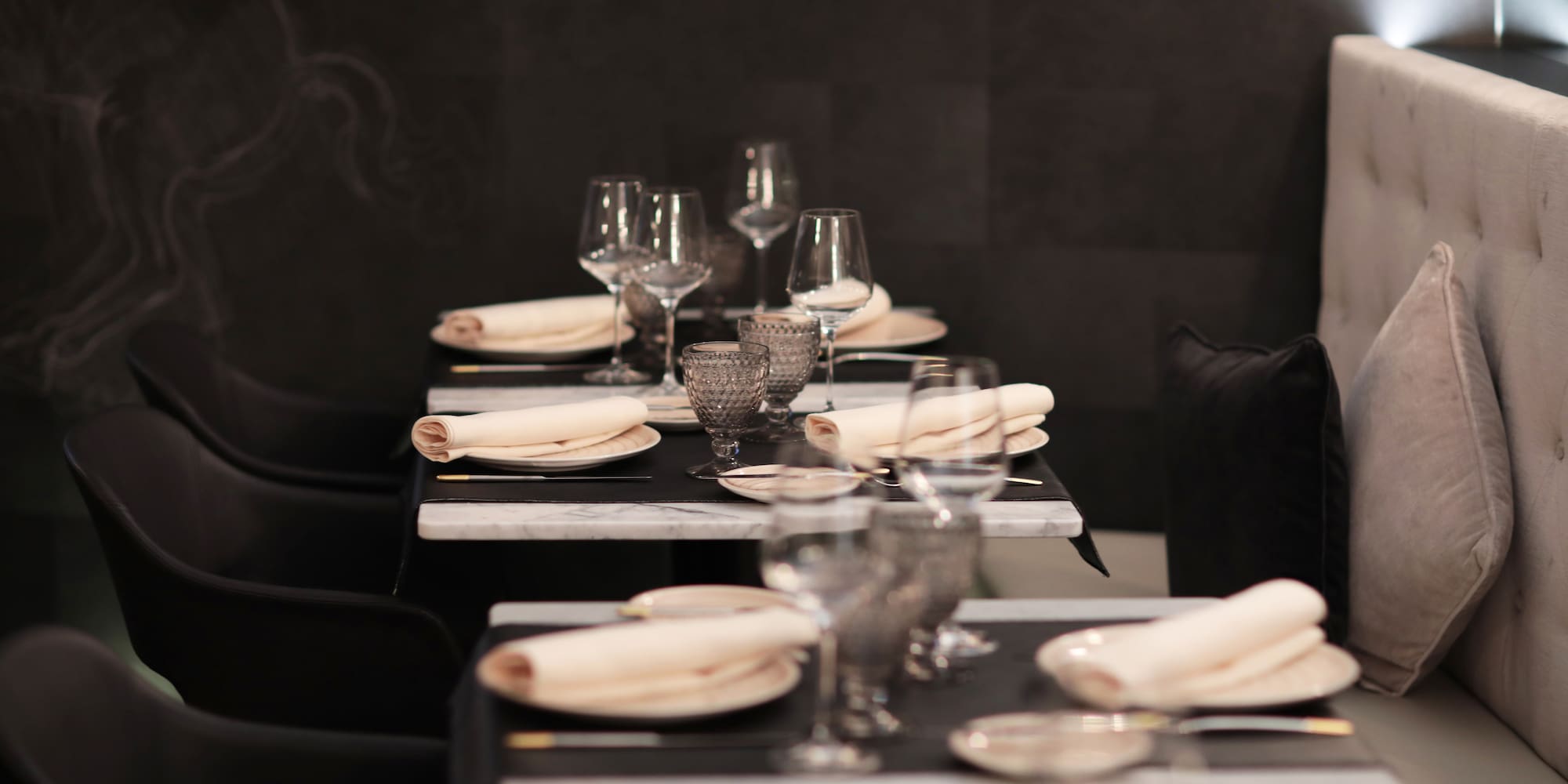 a table with glasses and napkins