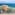 Chiringuito Guadalmar, modern beach bar with wavy colorful roof, sandy beach, ocean.