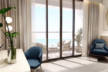 a room with a table and chairs and a table with chairs and a table with a view of the ocean