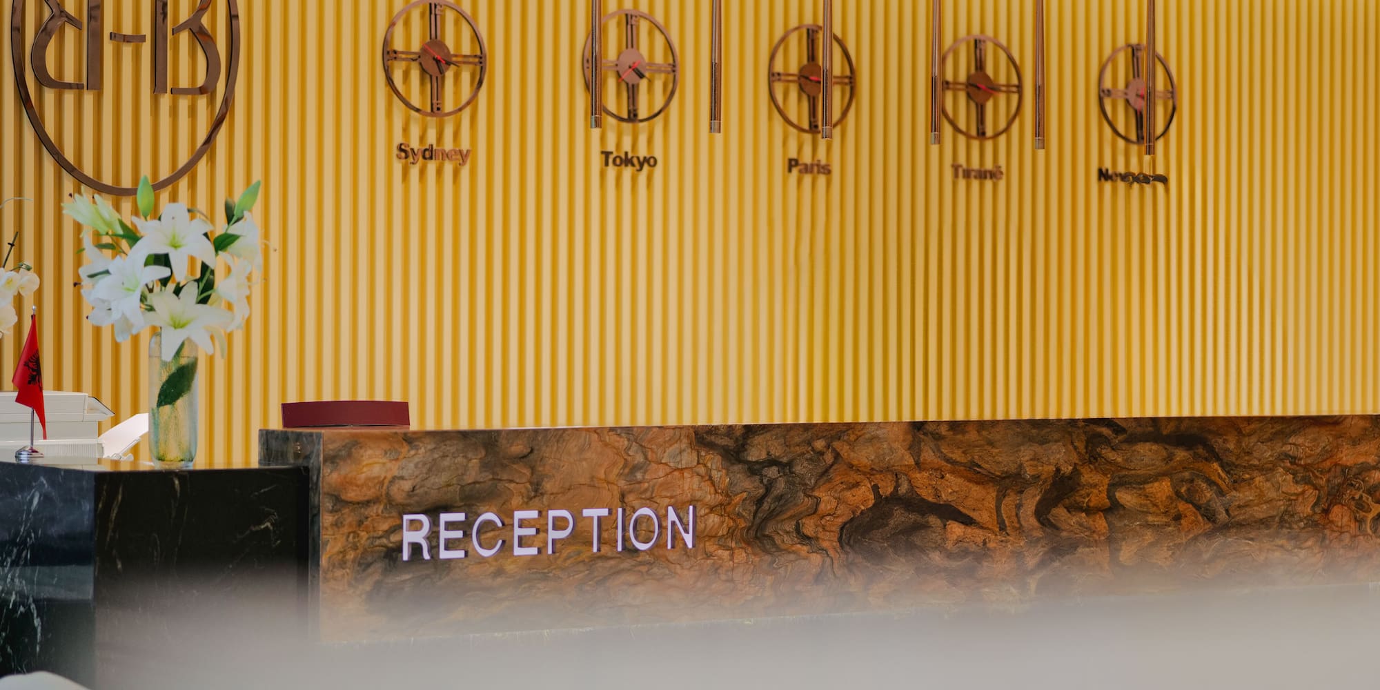 a reception desk with a sign on the wall