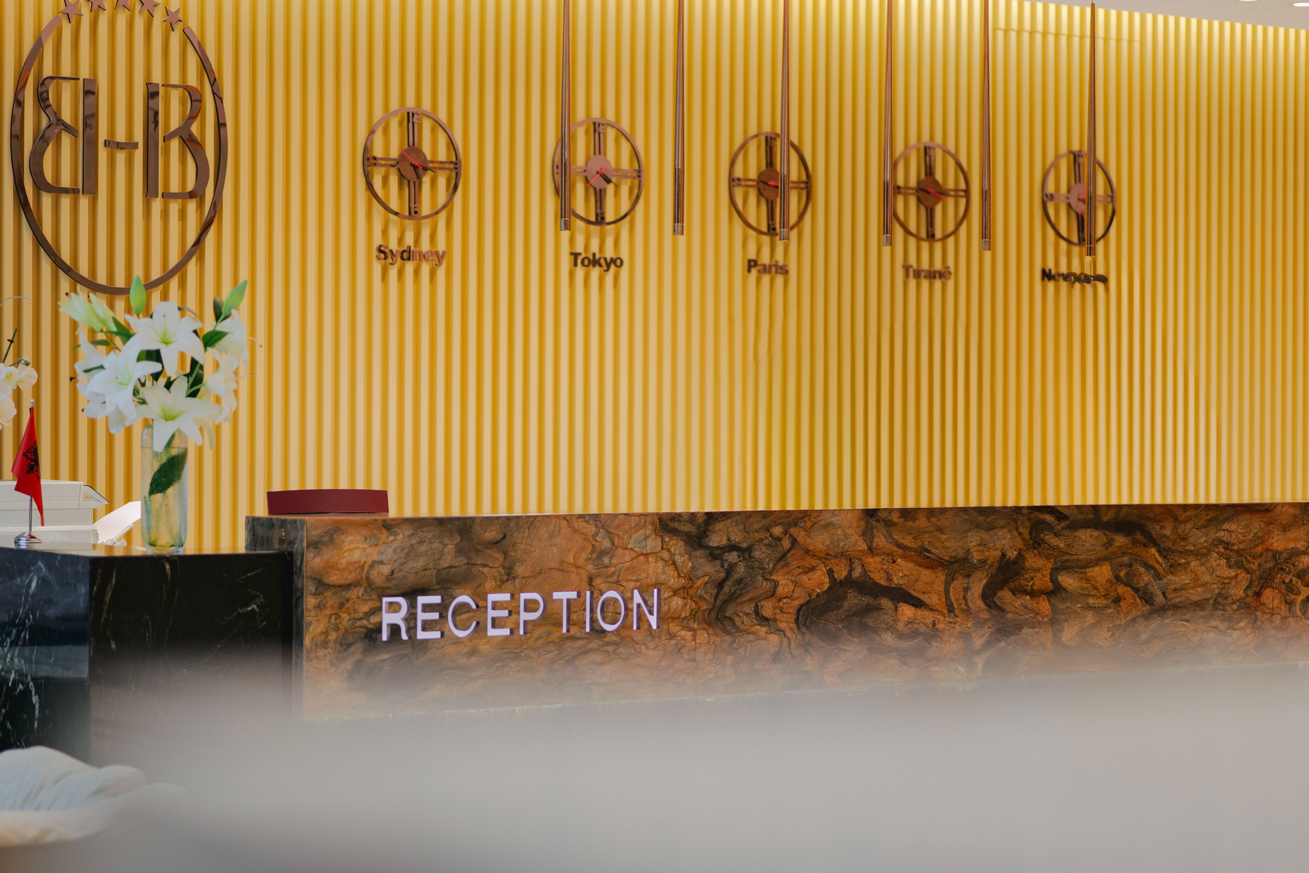 a reception desk with a sign on the wall