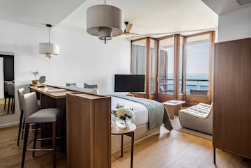 a room with a bed and a table and chairs