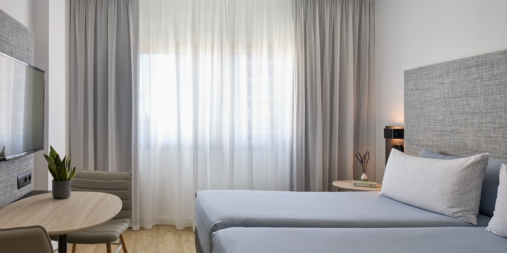 a room with two beds and a table