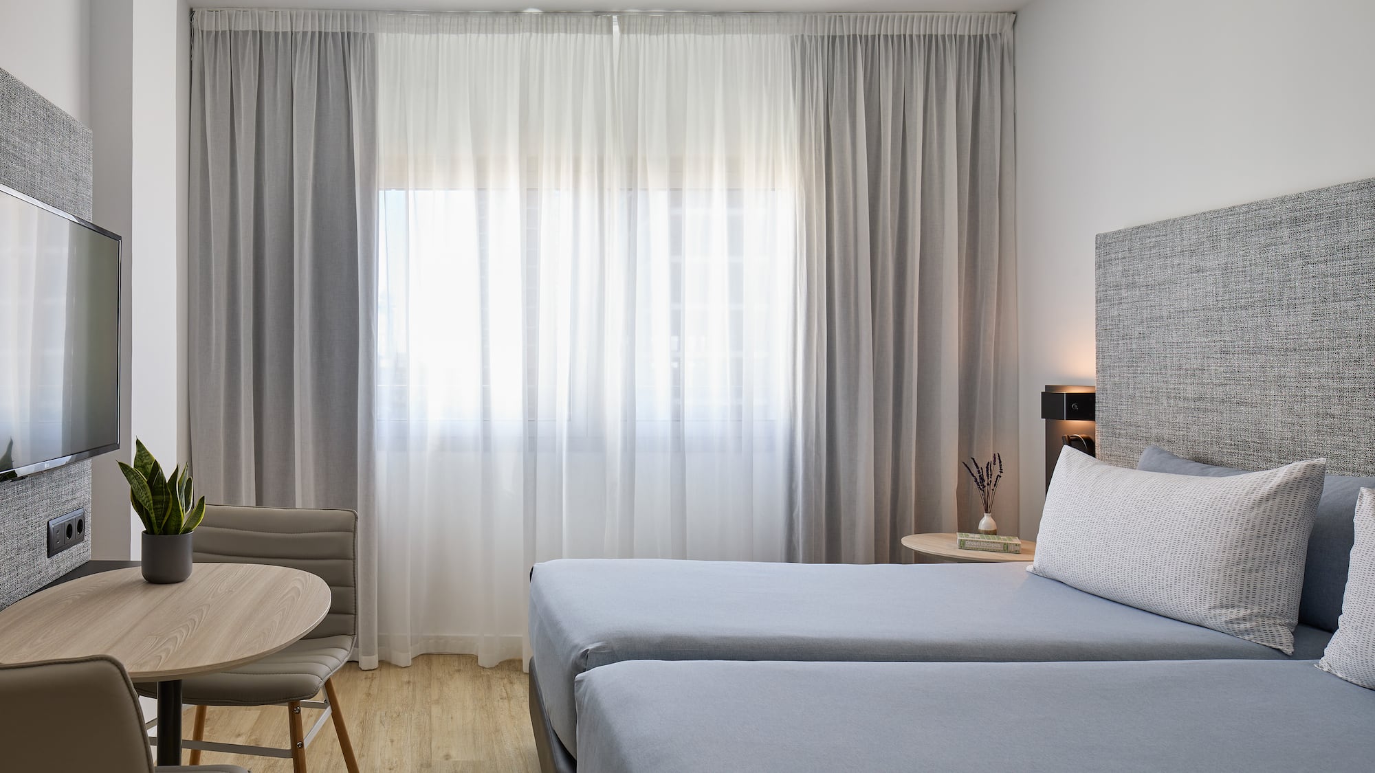 a room with two beds and a table