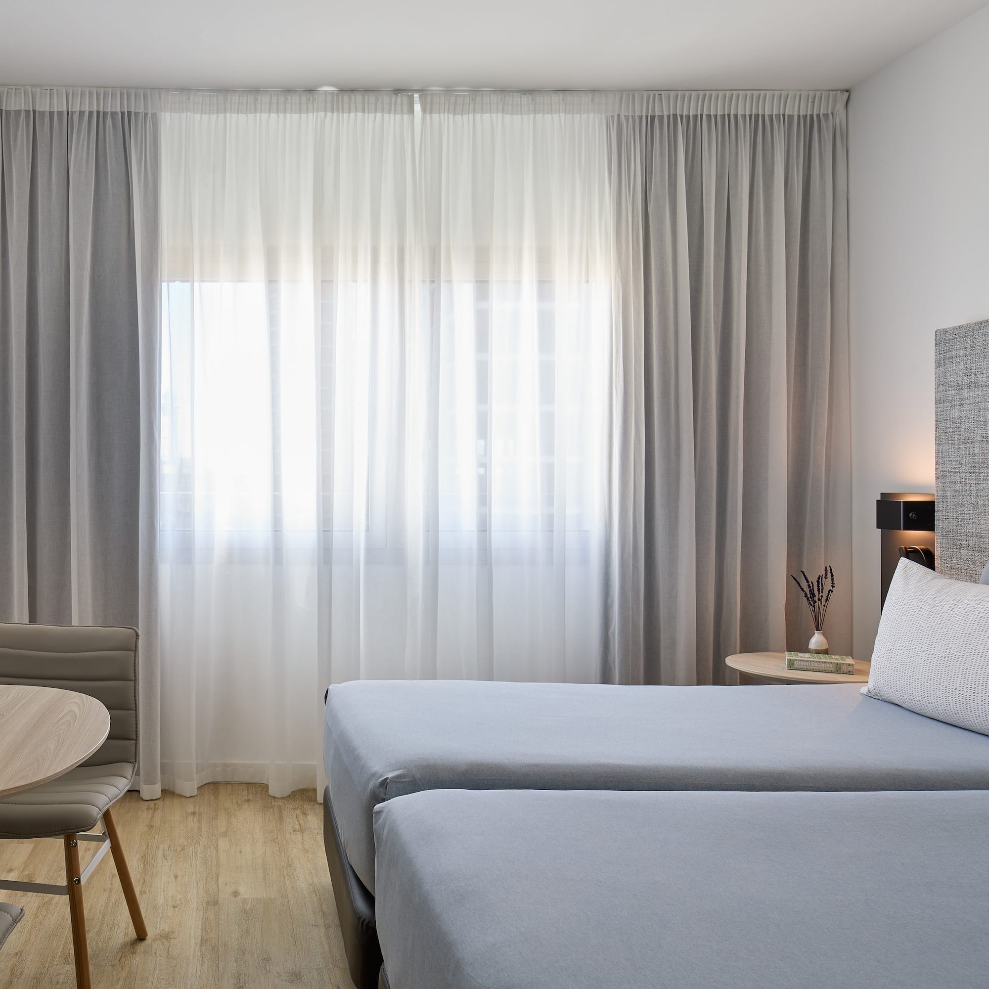 a room with two beds and a table