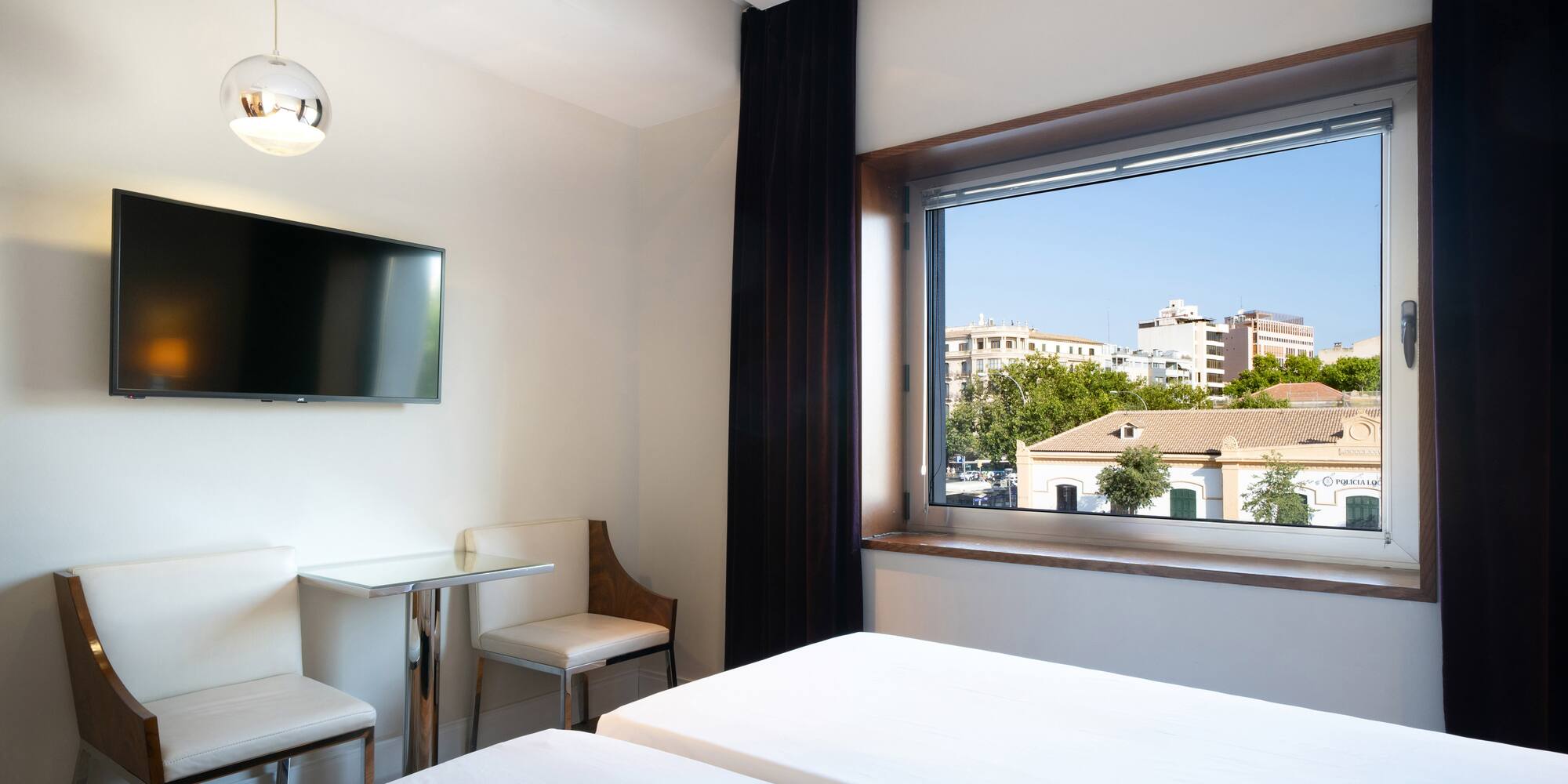 a room with a window and a bed