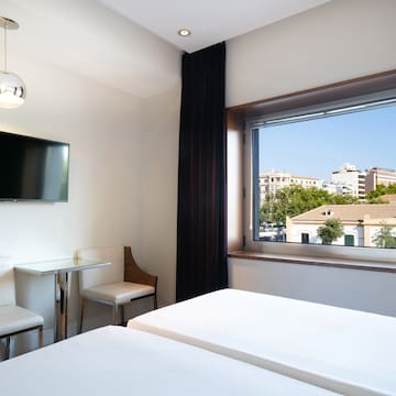 a room with a window and a bed