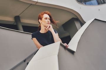 a woman leaning on a railing