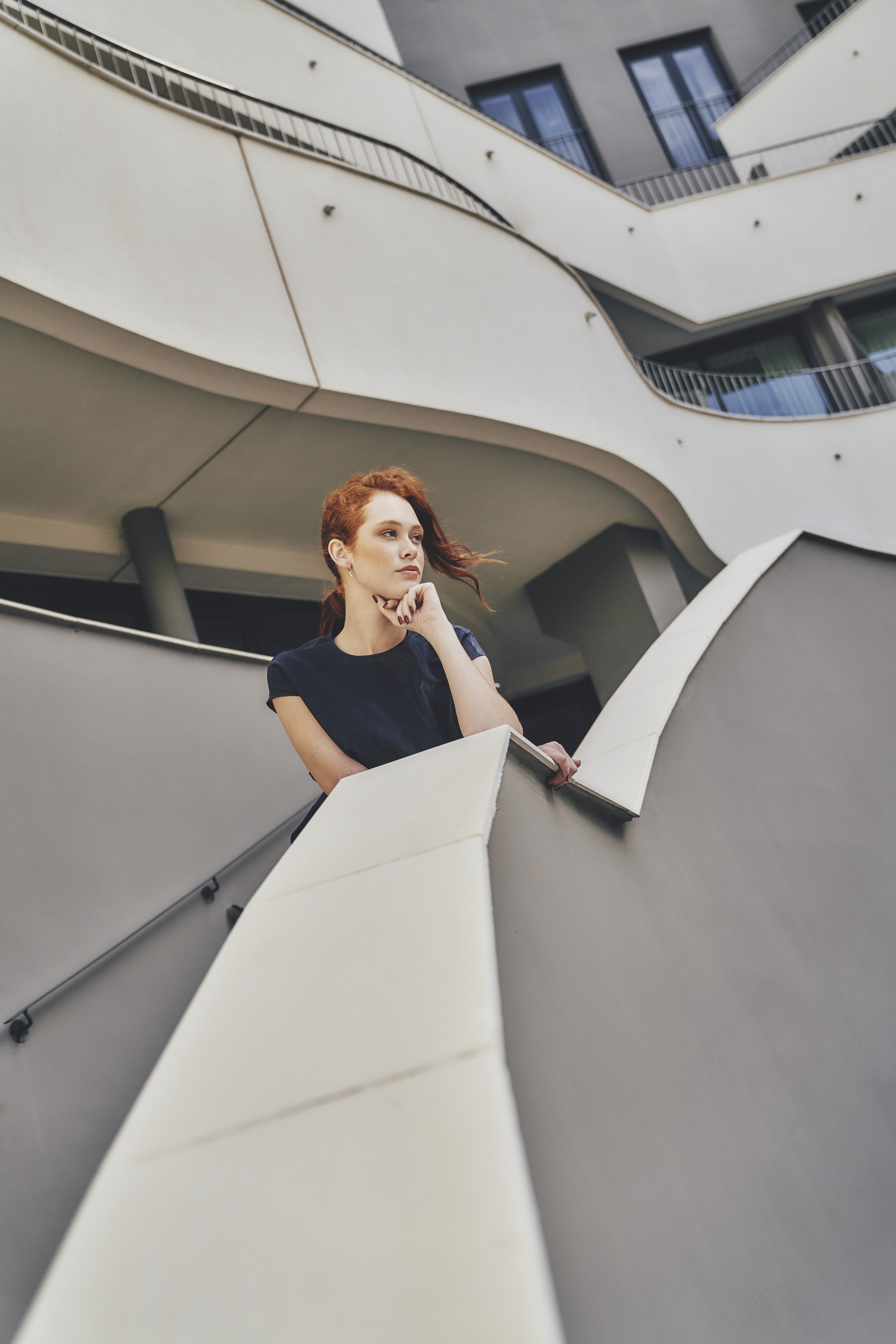 a woman leaning on a railing