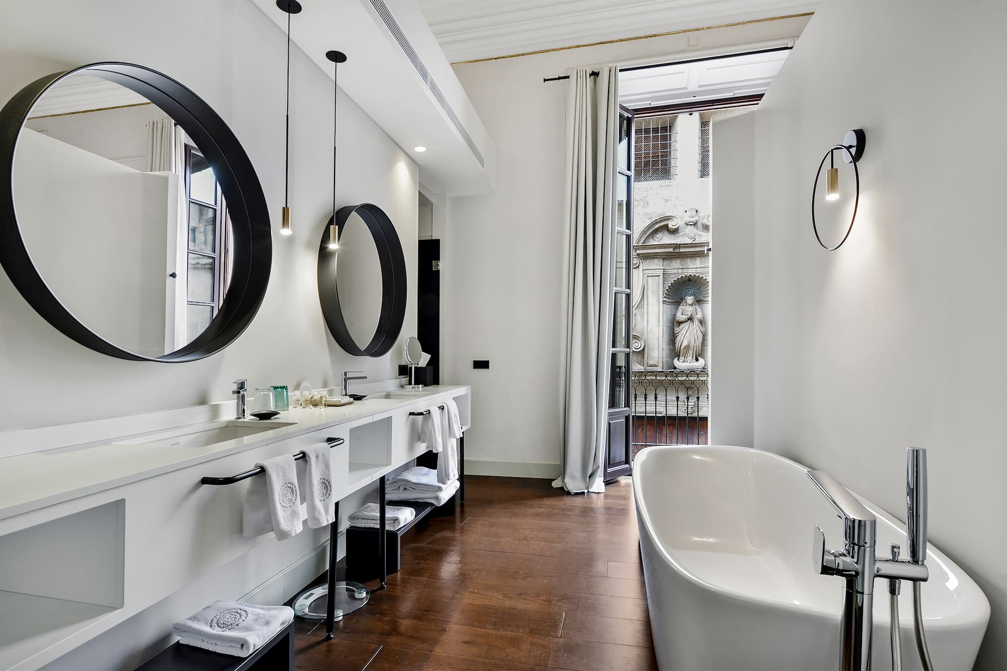 a bathroom with a tub and mirrors