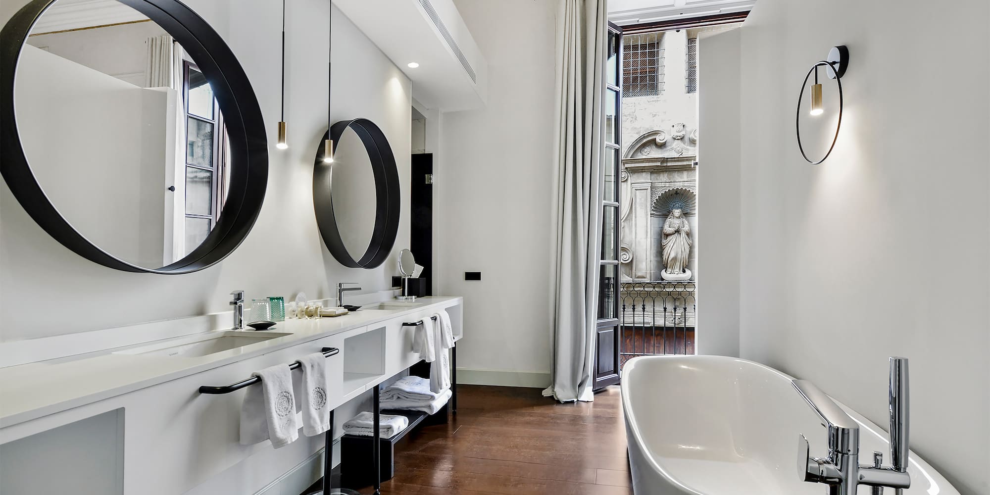 a bathroom with a tub and mirrors