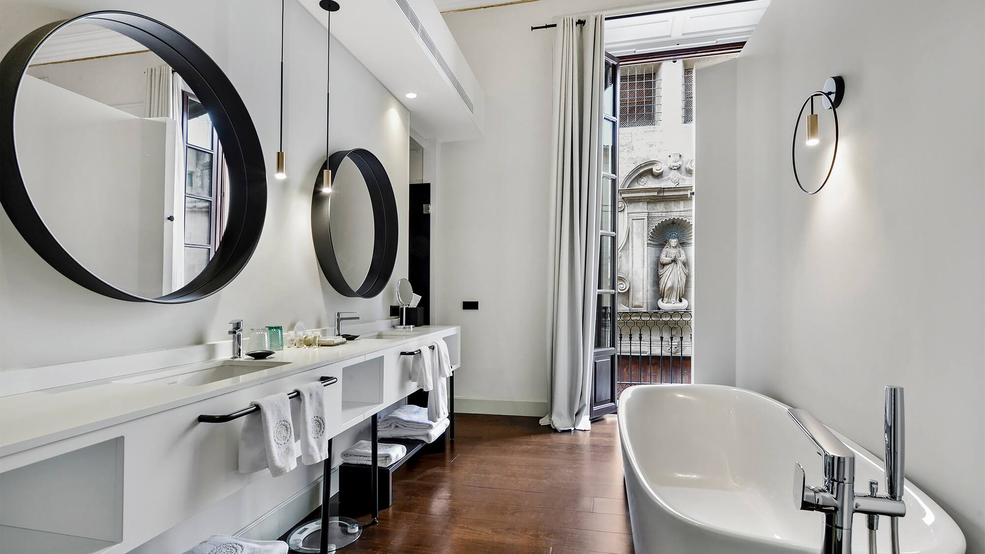 a bathroom with a tub and mirrors