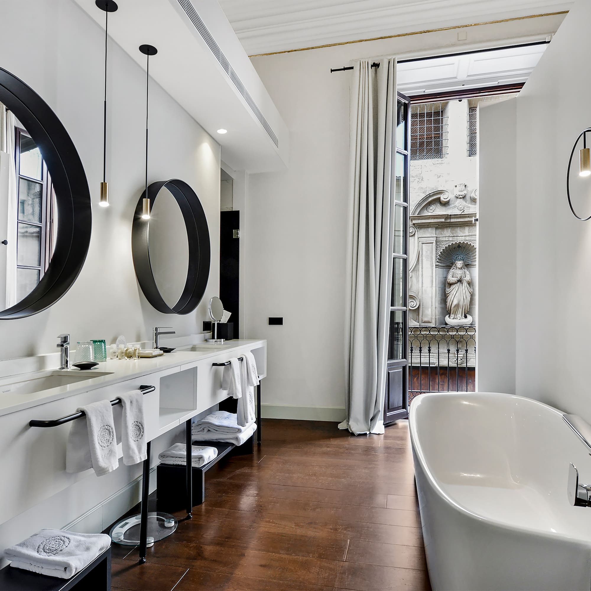 a bathroom with a tub and mirrors