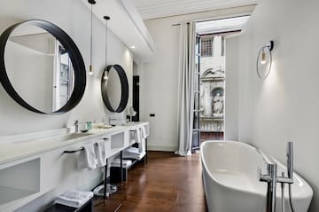 a bathroom with a tub and mirrors
