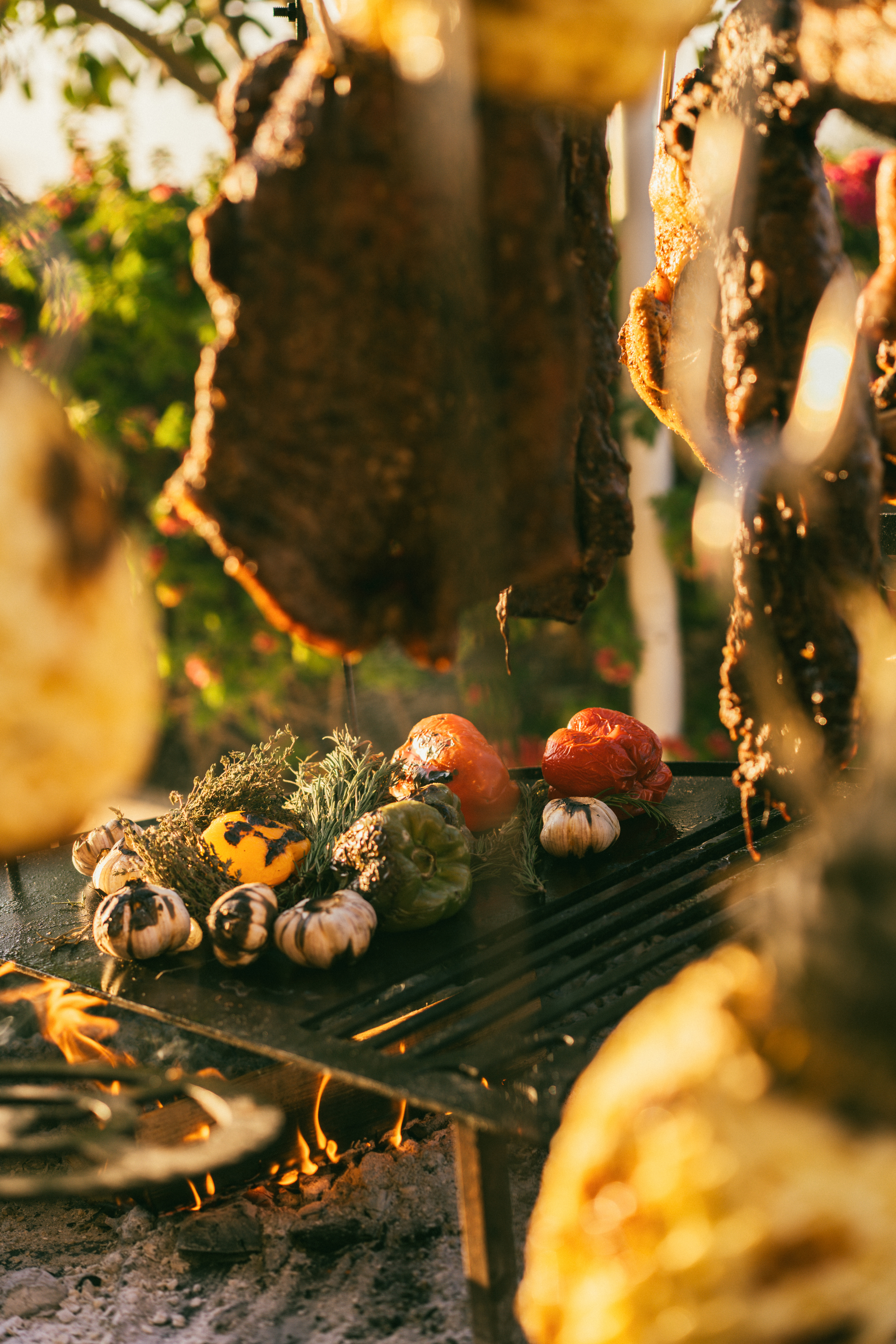 meat on a grill with vegetables