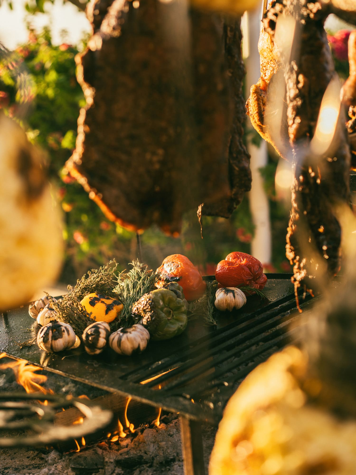 meat on a grill with vegetables
