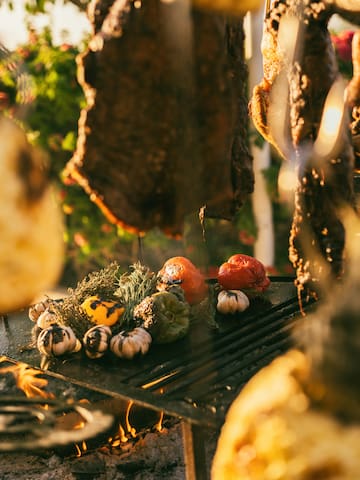 meat on a grill with vegetables