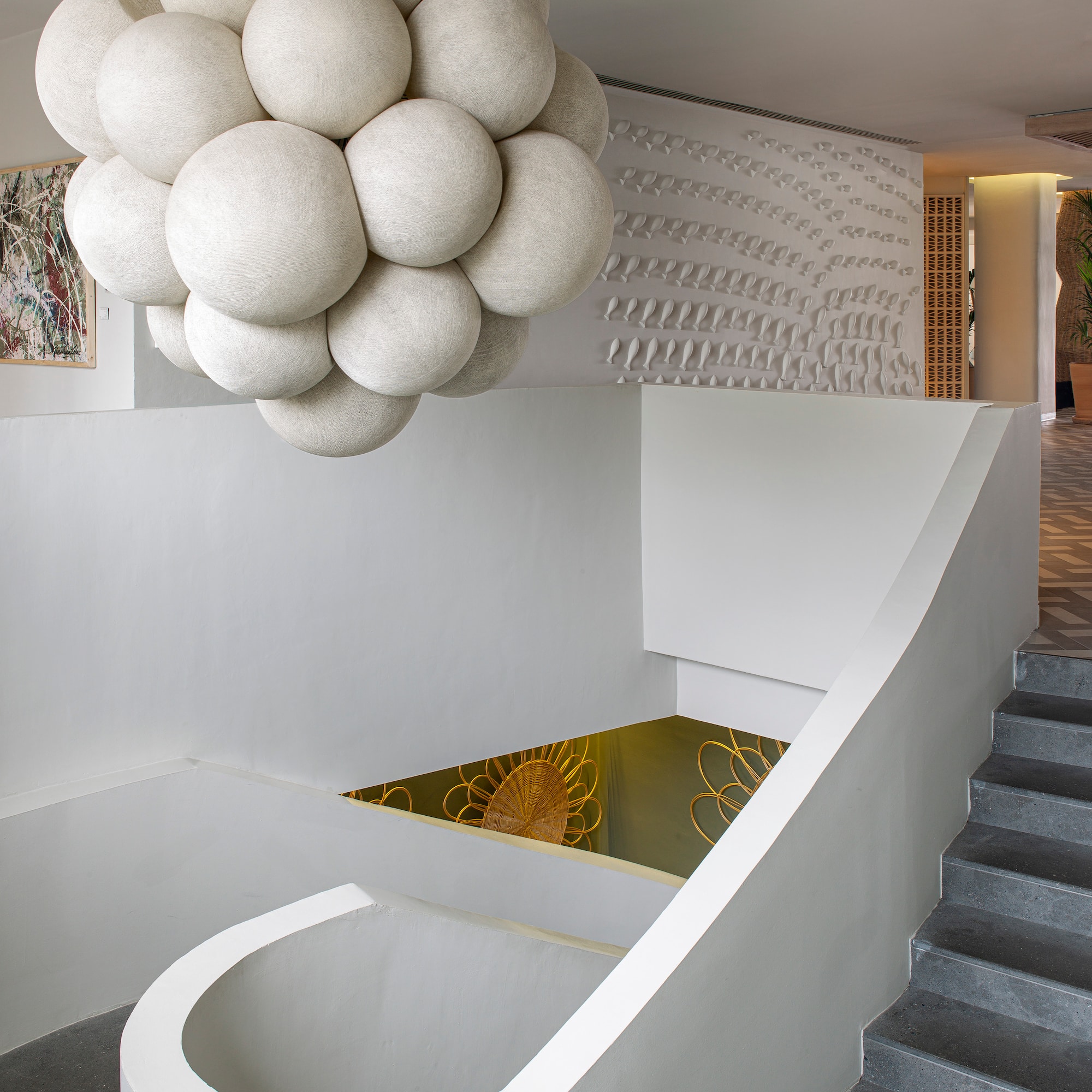 a white staircase with a large chandelier