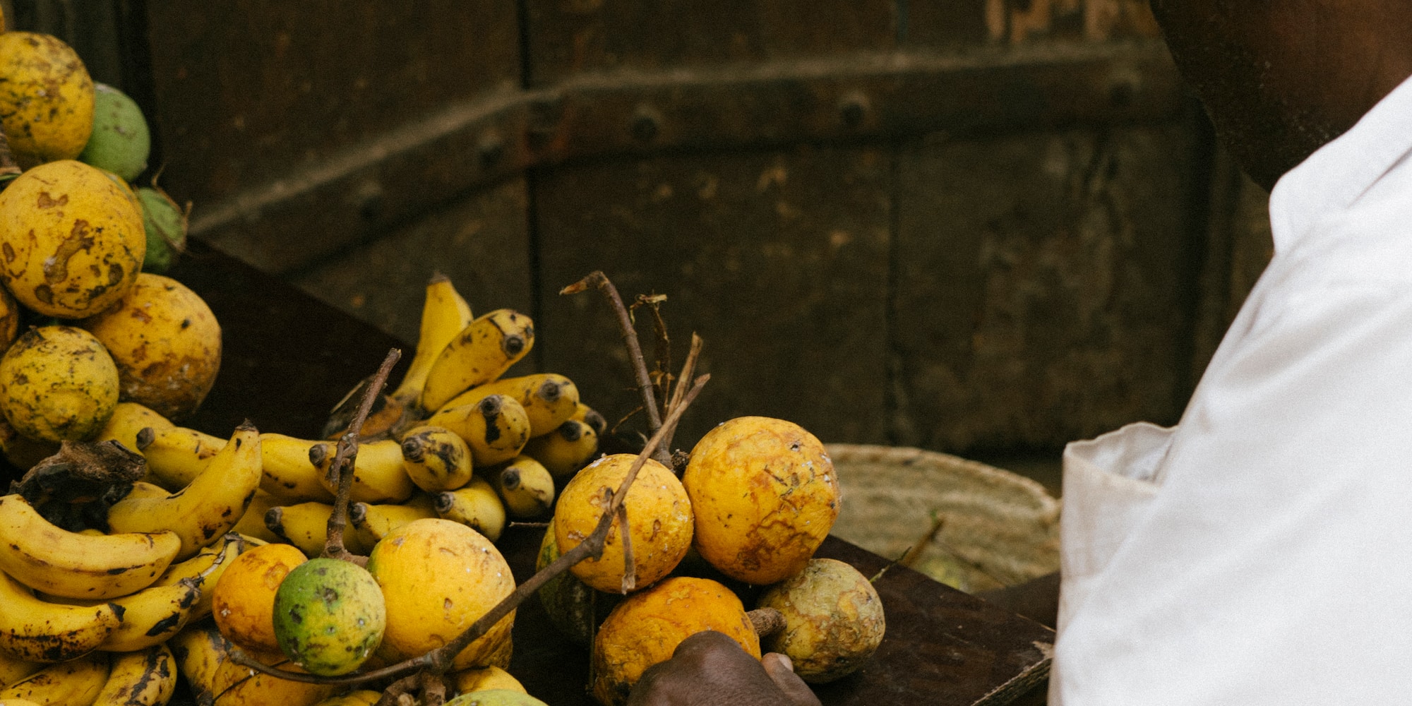a man holding a tray of fruit