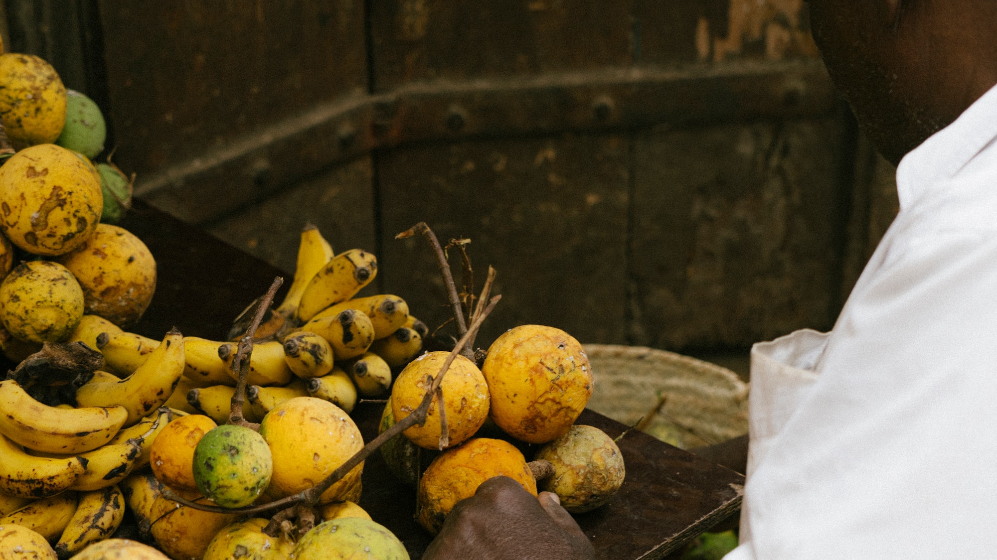 a man holding a tray of fruit