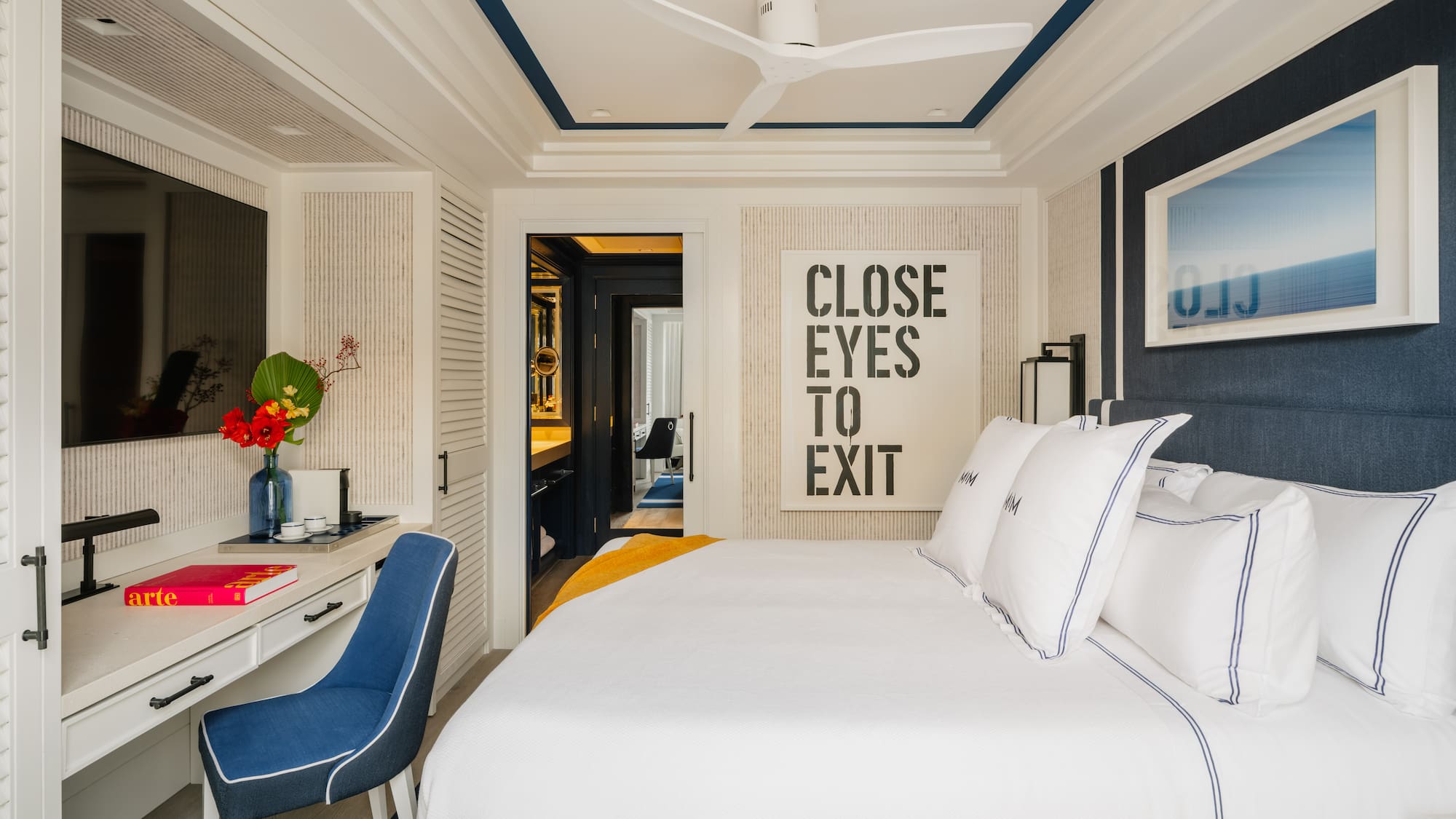 a bedroom with a bed and a desk