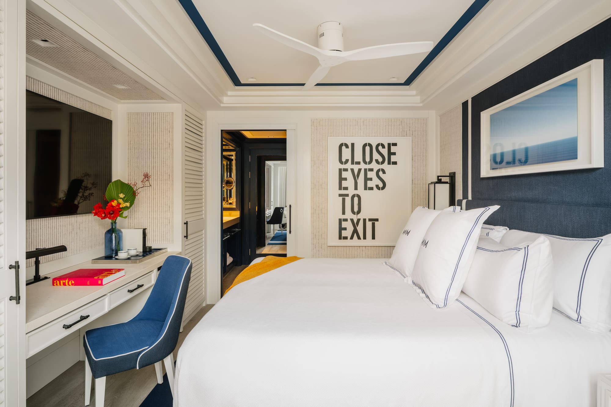 a bedroom with a bed and a desk