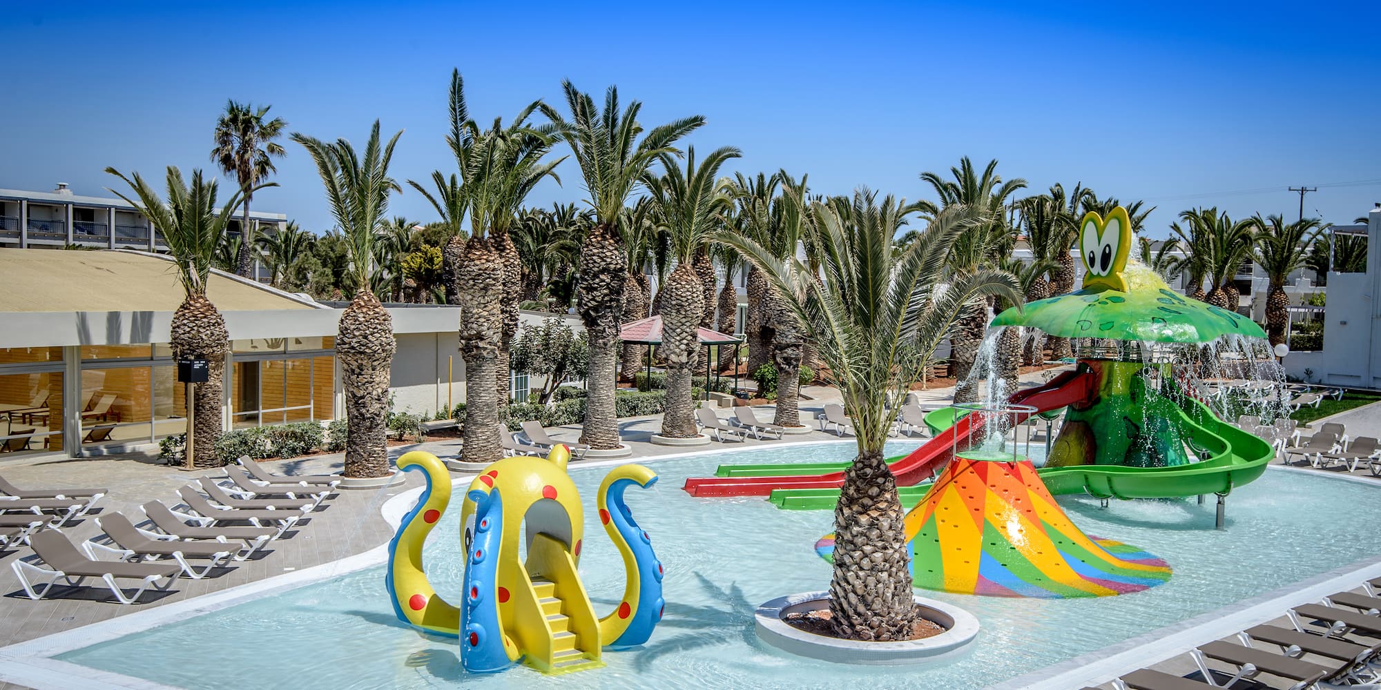 a water park with a slide and trees