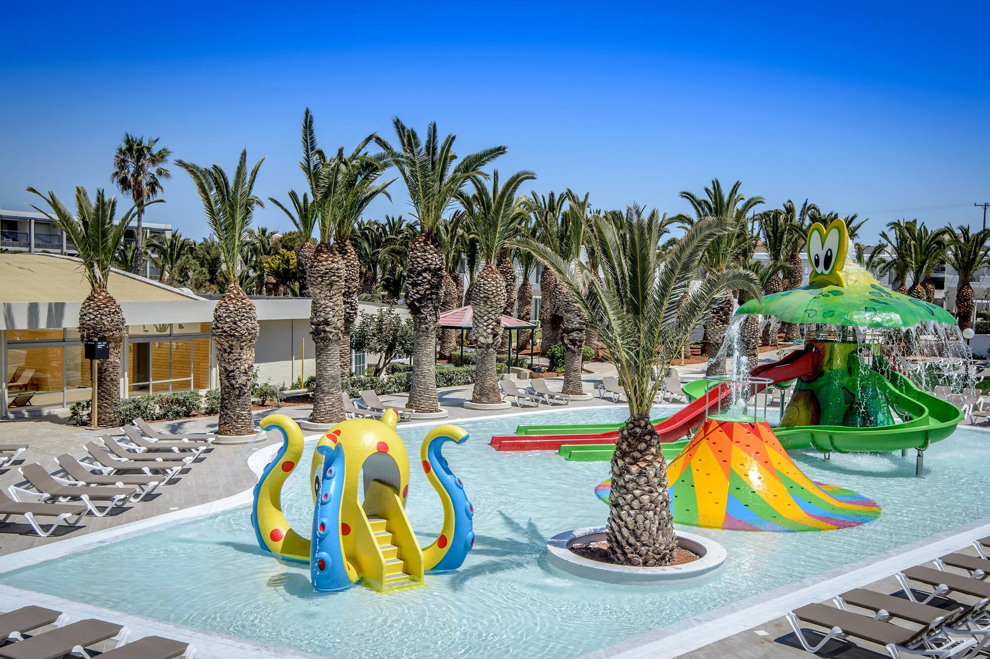 a water park with a slide and trees