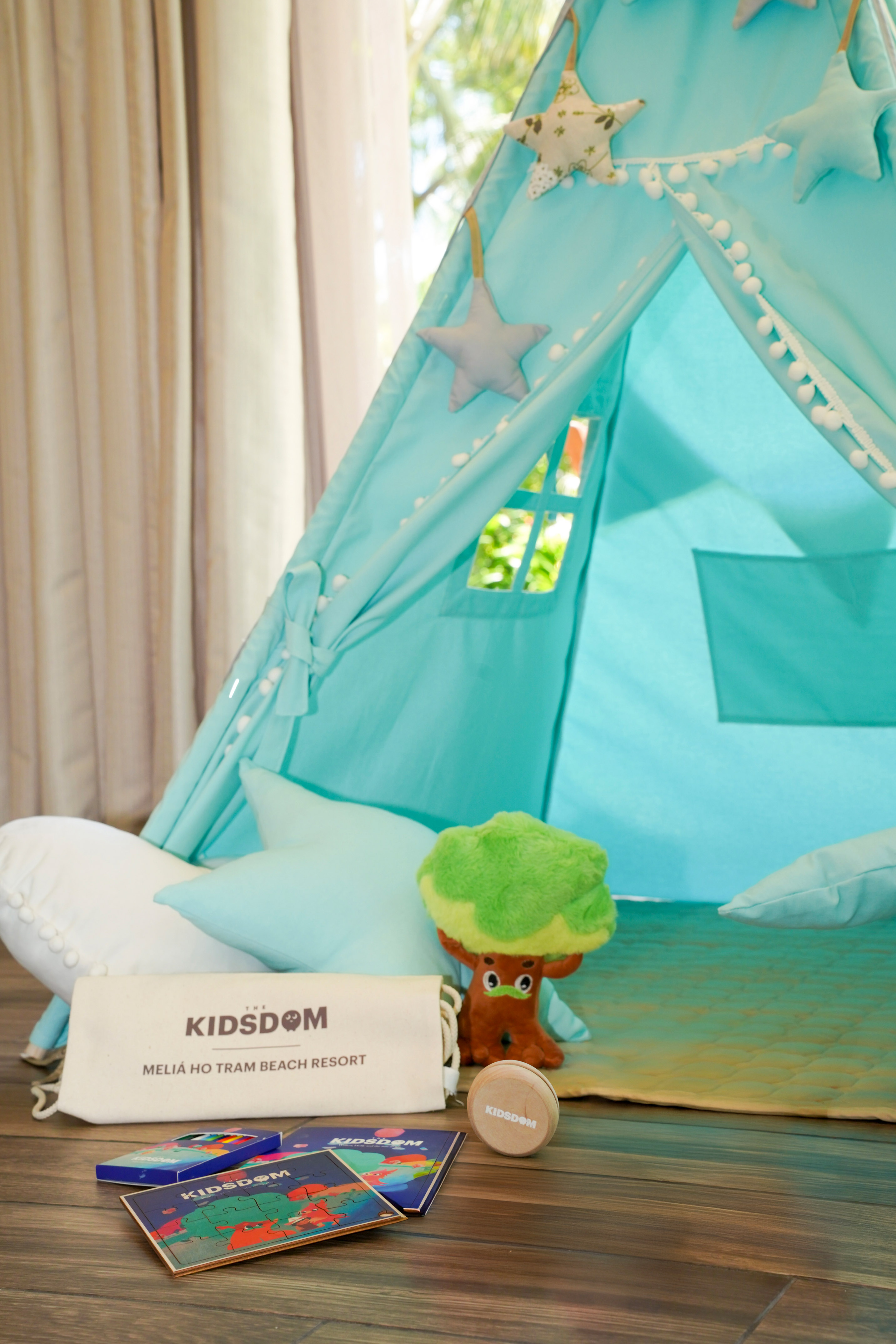 Teal kids' teepee tent, Kidsdom bag, puzzles, toy. Meliá Ho Tram Resort.