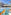 Hotel water park with colorful slides, splash pad, and palm trees.