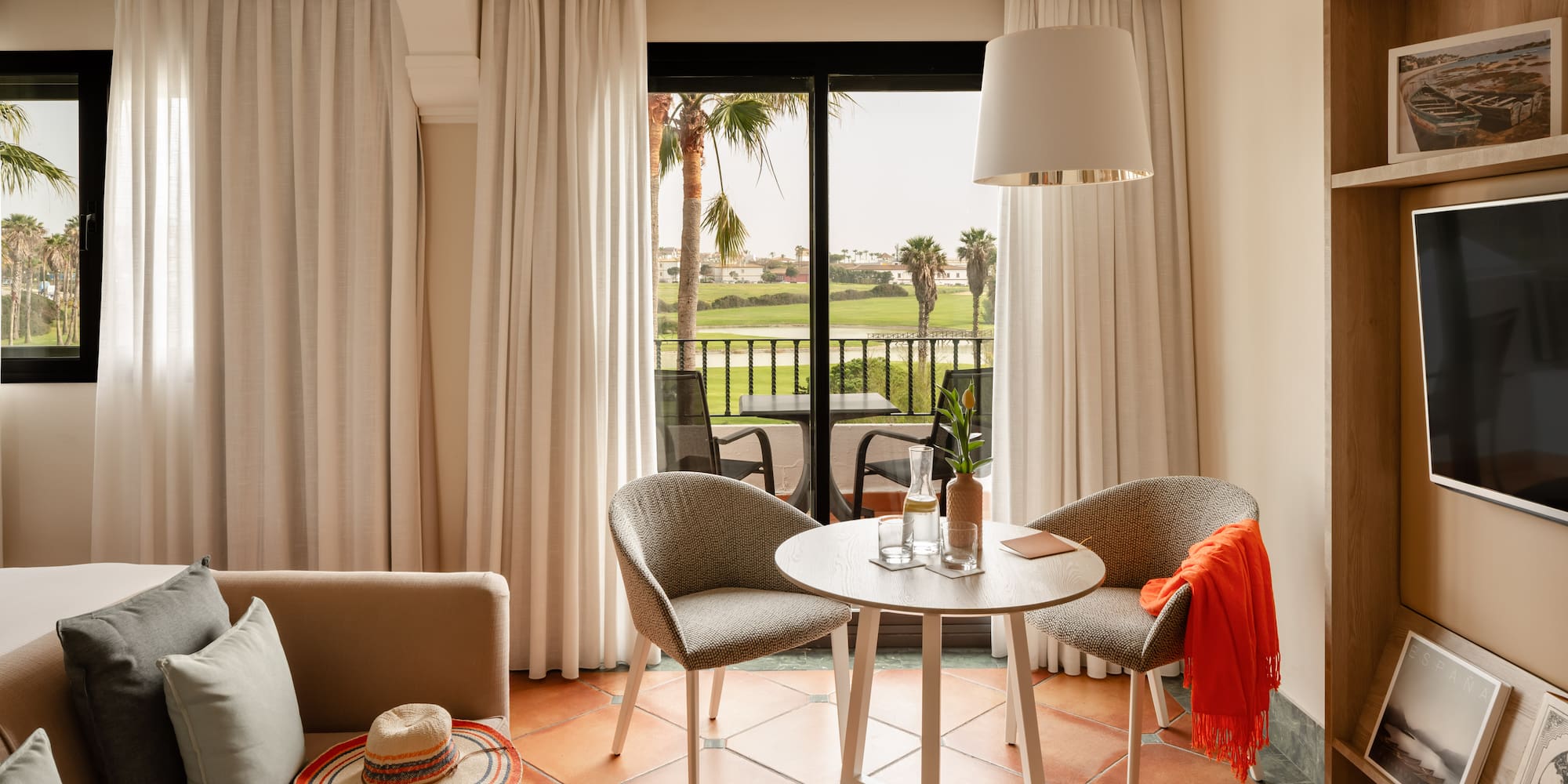 a room with a table and chairs and a chair and a table with a hat