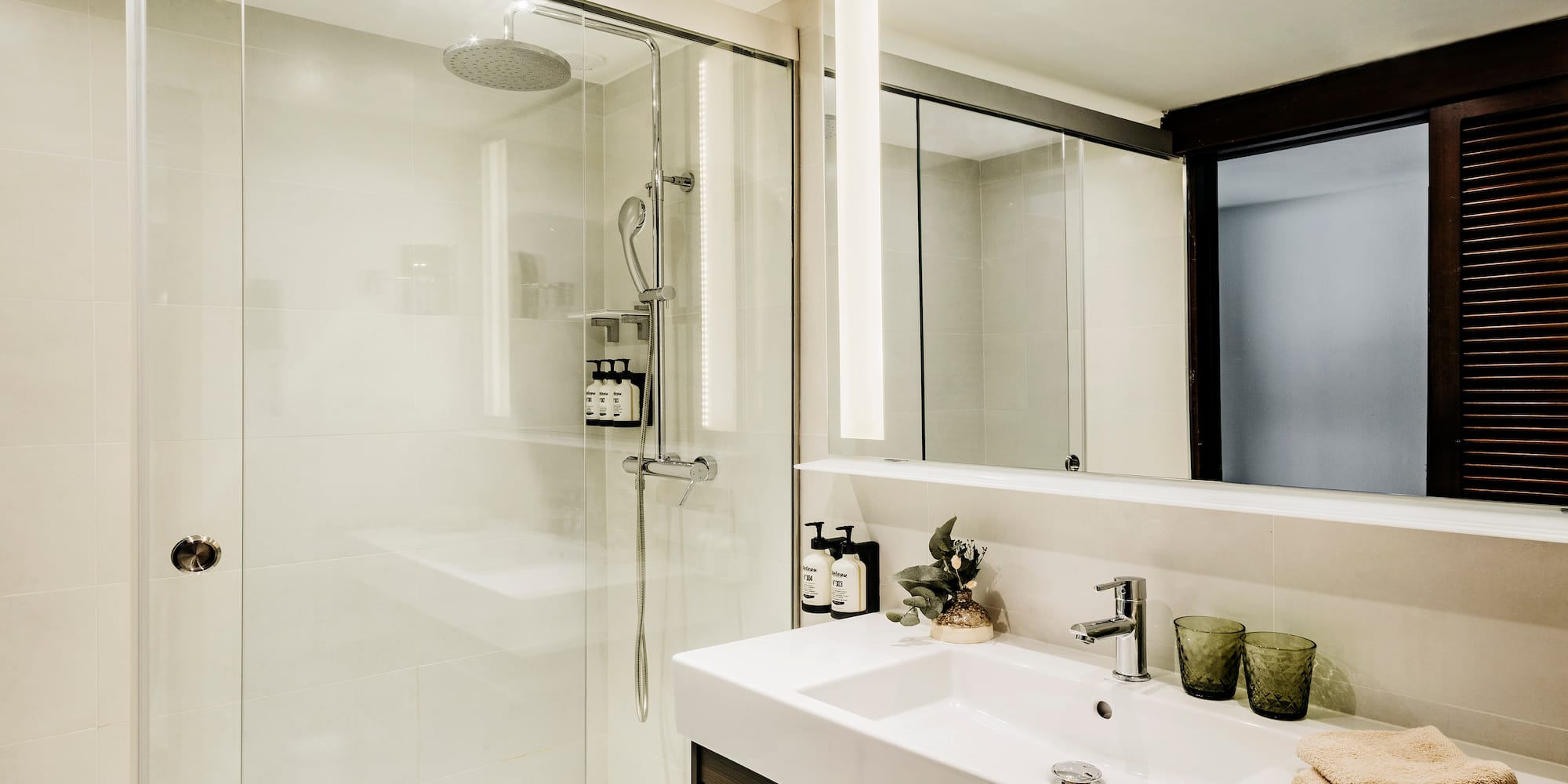 a bathroom with a shower and sink