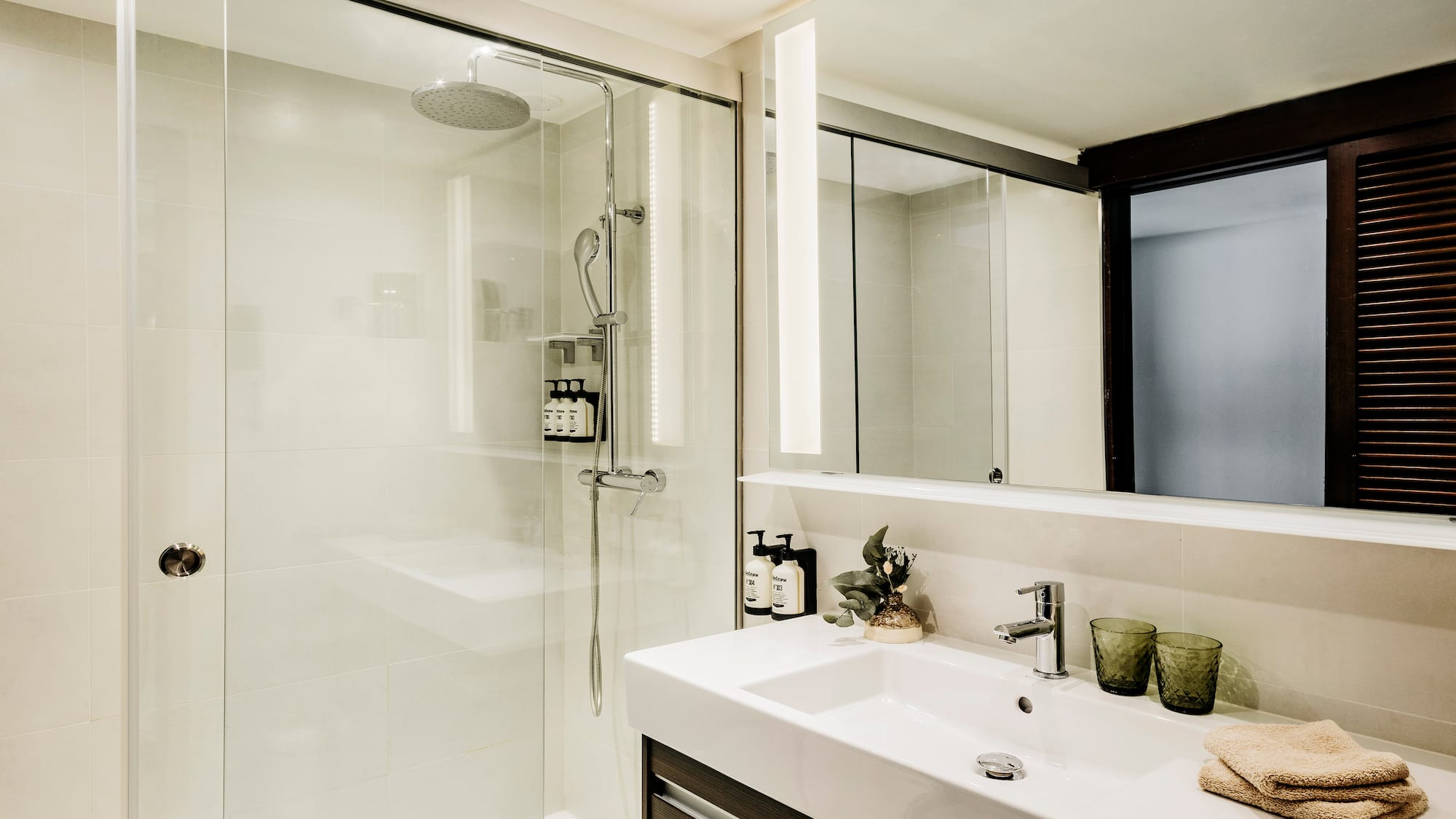 a bathroom with a shower and sink